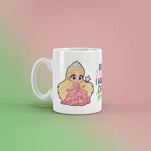 May include: White ceramic mug featuring a cartoon princess in a pink dress, tiara, and wand. The mug has the text "Because I have to, I have chores, for sure!" in black and green. A fun, whimsical design.