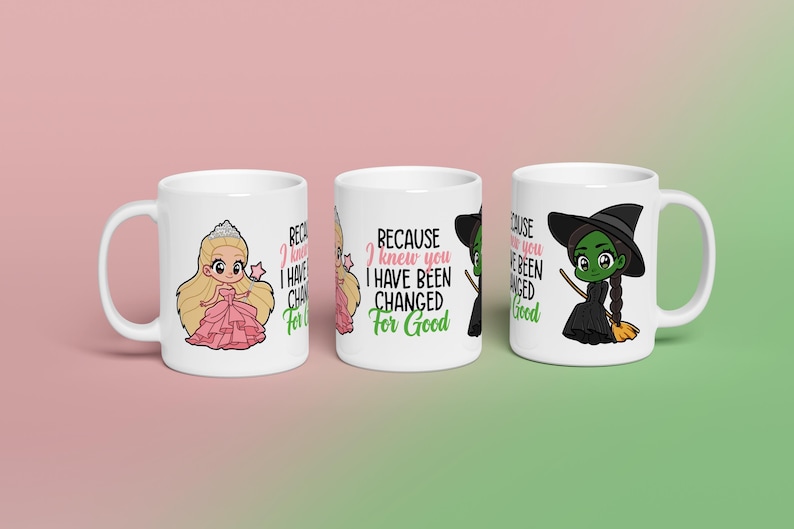 May include: Three white ceramic mugs with cartoon illustrations. One mug features a princess, another has text that reads "BECAUSE I KNEW YOU I HAVE BEEN CHANGED FOR GOOD", and the third depicts a green witch. The mugs are on a pink and green gradient background.