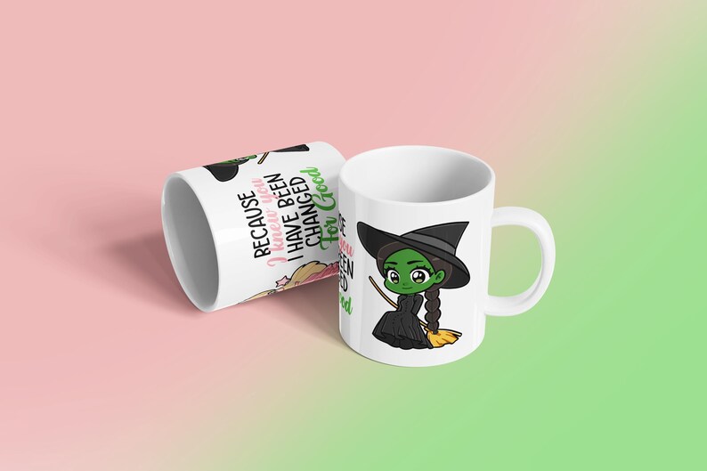 May include: White ceramic mug featuring a cartoon witch with green skin, a black hat, and a black dress, holding a broom. The mug also has the text "Because I knew you I have been changed for Good."