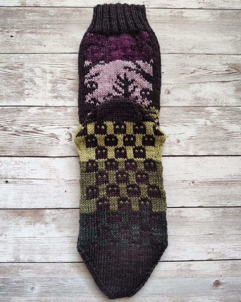 May include: A brown, green, and purple knitted sock with a checkered pattern. The sock is made with a variety of yarns and has a unique design.