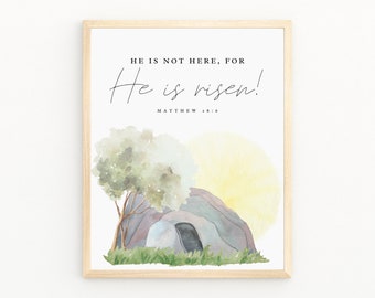 Puede incluir: Impresión enmarcada con el texto "He is not here, for He is risen!" y Mateo 28:6. La ilustración en acuarela representa una tumba, un árbol y un sol amarillo. El marco es marrón claro.