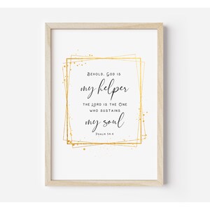 May include: A white printable art print with gold accents and the text "BEHOLD. GOD IS my helper THE LORD IS THE ONE WHO SUSTAINS my soul PSALM 54:4"