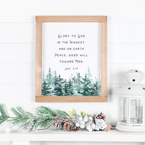 Peut inclure: Une impression encadr&eacute;e avec une peinture &agrave; l'aquarelle d'une for&ecirc;t enneig&eacute;e. L'impression pr&eacute;sente le texte "Gloire &agrave; Dieu au plus haut. Et sur la terre Paix. Bonne volont&eacute; envers les hommes. Luc 2:14".