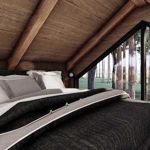 May include: A cozy bedroom with a bed covered in a dark gray comforter and white pillows. The room has wooden walls and ceiling, and a large triangular window offering a view of a forest.