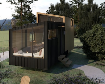 May include: A small, modern, black and wood cabin with large windows and a wooden deck. The cabin is surrounded by trees and grass.
