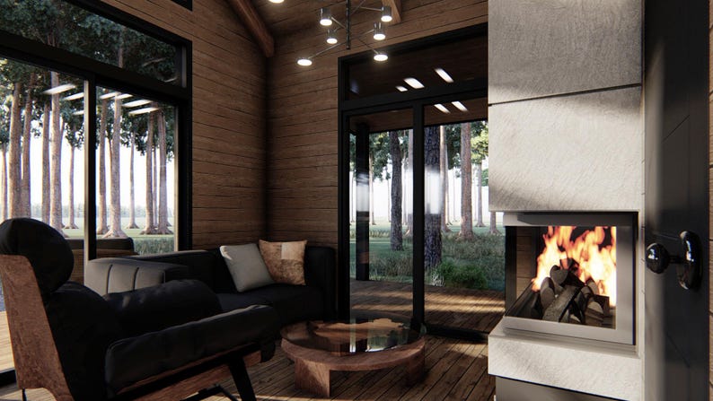 May include: Interior shot of a modern living room with a fireplace. The room features a black sofa, a wooden coffee table, and large windows overlooking a forest. A fire burns brightly in the fireplace, creating a warm ambiance.