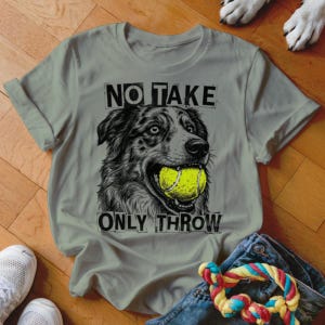 May include: A light gray t-shirt featuring a black and white illustration of a dog with a tennis ball in its mouth. The text "NO TAKE ONLY THROW" is printed above and below the dog image.