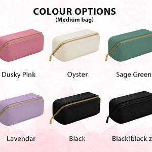 May include: A selection of medium-sized cosmetic bags in various colors, including dusky pink, oyster, sage green, lavender, and black. Each bag has a gold-colored zipper and a rectangular shape. The text "COLOUR OPTIONS" is at the top.