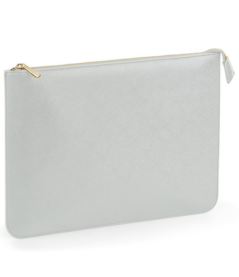 May include: A silver zippered pouch with a gold zipper pull.