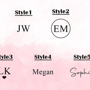 May include: Five different styles of personalized name or monogram designs. Style 1 shows the initials "JW" in a simple, block font. Style 2 shows the initials "EM" in a circle. Style 3 shows the initials "LK" with a small heart below. Style 4 shows the name "Megan" in a simple, block font. Style 5 shows the name "Sophia" in a cursive font.
