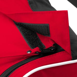 May include: A red and black fabric bag featuring a flap closure secured with a black hook-and-loop fastener strip. The bag includes a black zip with a metal pull tab, a white piping detail along the edge, and a textured black fabric panel.