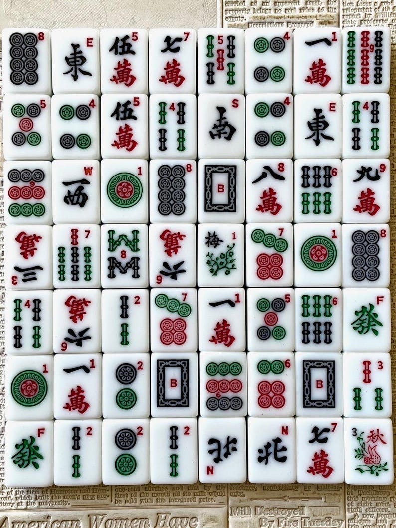 May include: A set of 36 white mahjong tiles with black and green bamboo, circle, and character symbols. The tiles are arranged in a grid pattern and include numbers 1 through 9, wind symbols, and dragon symbols.