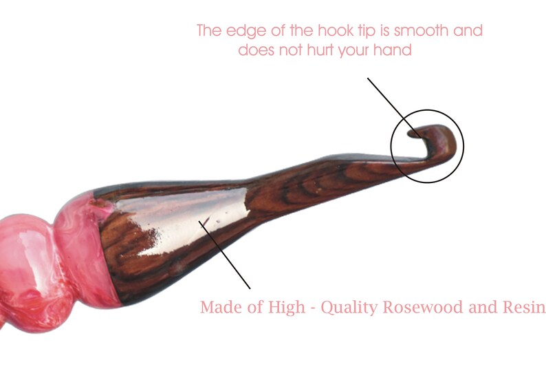 May include: A close-up of a wooden crochet hook with a pink and brown resin handle. The hook tip is smooth and rounded. "Made of High - Quality Rosewood and Resin" is written below the hook.