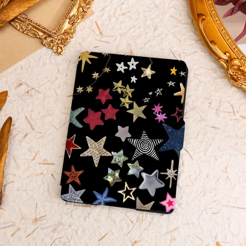 May include: A black e-reader cover with a colorful star pattern. The stars are in various sizes and colors, including red, blue, gold, and silver.