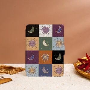May include: A colorful e-reader cover with a repeating pattern of suns and moons in a retro style.