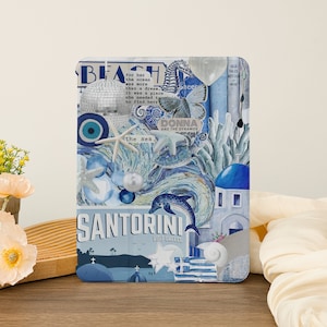 May include: A collage of blue and white images with a beach theme. The collage includes a seashell, a starfish, a dolphin, a blue and white eye, a disco ball, a seahorse, a butterfly, and a Greek island scene. The text "SANTORINI VISIT GREECE" is at the bottom of the collage.