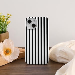May include: A black and white striped phone case for an iPhone.
