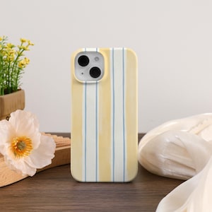 May include: A yellow and white striped phone case. The case has a vertical stripe design with alternating yellow and white stripes, and a light blue accent stripe. The case is designed to fit a smartphone and has cutouts for the camera and buttons.