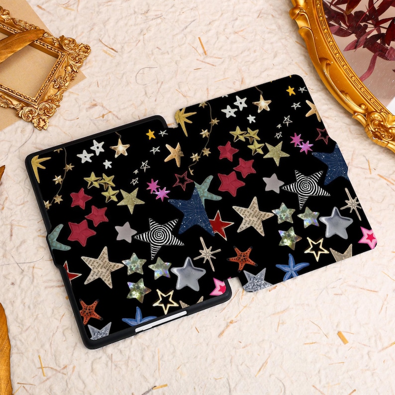 May include: A black e-reader case with a colorful star pattern. The stars are in various sizes and colors, including red, blue, gold, and pink.