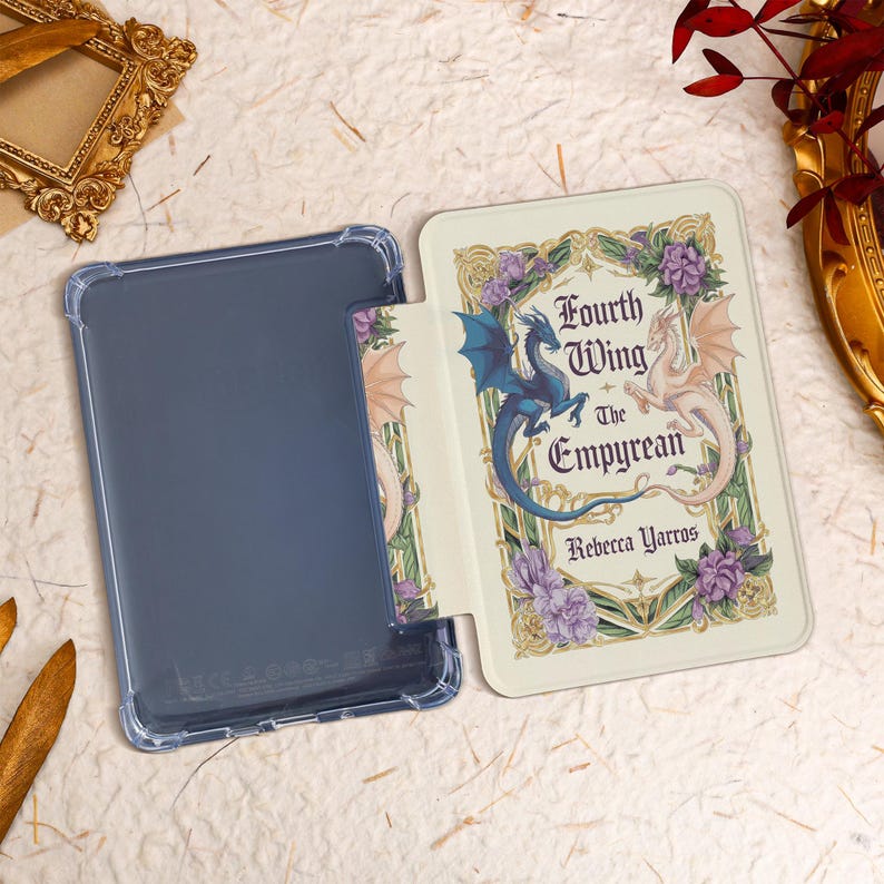 May include: A white and gold book cover with a blue and white dragon design. The title is "Fourth Wing: The Empyrean" by Rebecca Yarros.