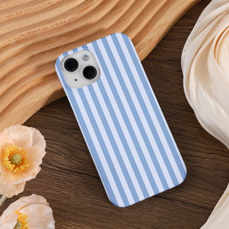 May include: A blue and white striped phone case for an iPhone.