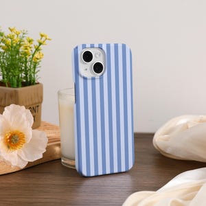 May include: A blue and white striped phone case for an iPhone. The case has a camera cutout and a white background.