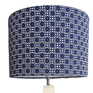May include: A blue and white patterned lampshade with a geometric design.