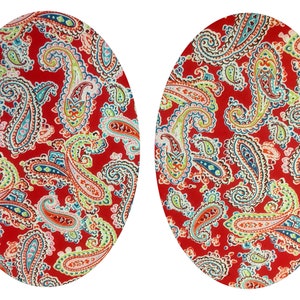 May include: Two red oval-shaped fabric coasters with a paisley pattern in shades of blue, green, and white.