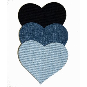 May include: Three denim heart-shaped patches in different shades of blue, with the darkest blue on top and the lightest blue on the bottom.