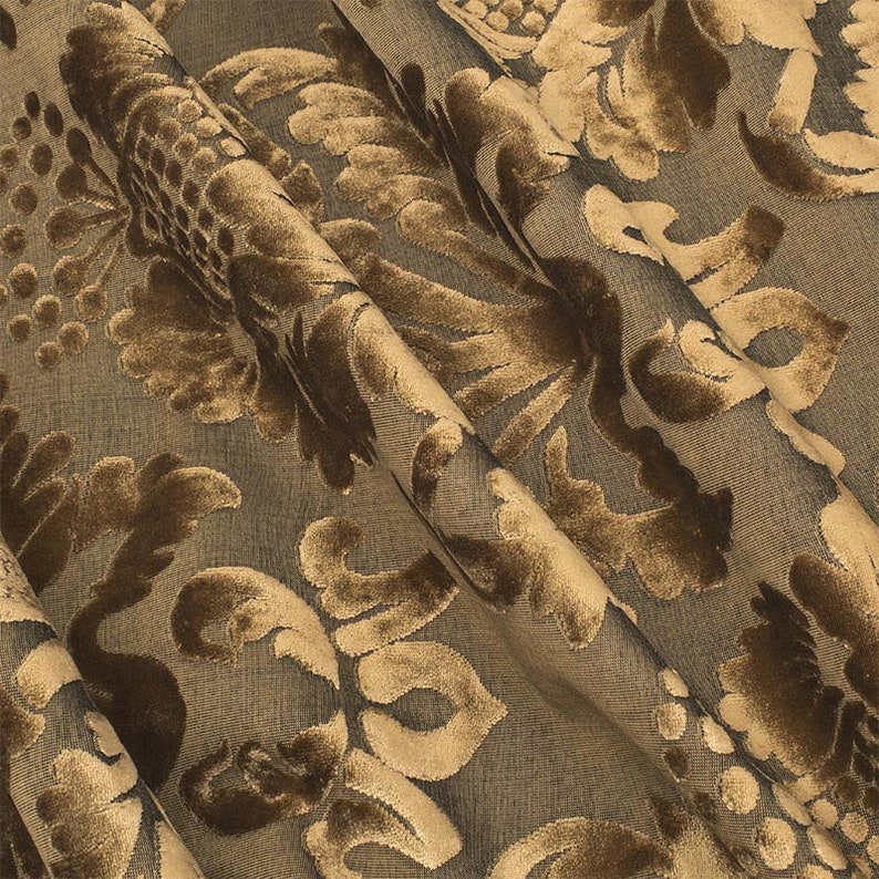 May include: Brown and gold fabric with a damask pattern. The fabric has a raised texture and a luxurious feel.