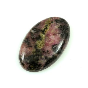 May include: A smooth, oval-shaped cabochon of pink and black rhodonite with a green and black marbling pattern.