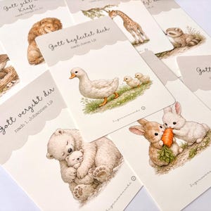 May include: A collection of illustrated cards featuring various animals, including a lion, giraffe, ducklings, and rabbits. Each card has a scalloped edge and text in German. The illustrations are in soft, muted colors.