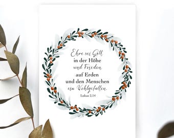 Puede incluir: Una tarjeta blanca con una corona verde y blanca con bayas rojas. La tarjeta tiene el texto "Ehre sei Gott in der Höhe und Frieden auf Erden und den Menschen ein Wohlgefallen. Lukas 2,14".