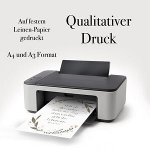 May include: A black and white printer with a sheet of paper emerging from the output tray. The paper has a floral design and text. The image also includes the text "Qualitativer Druck".