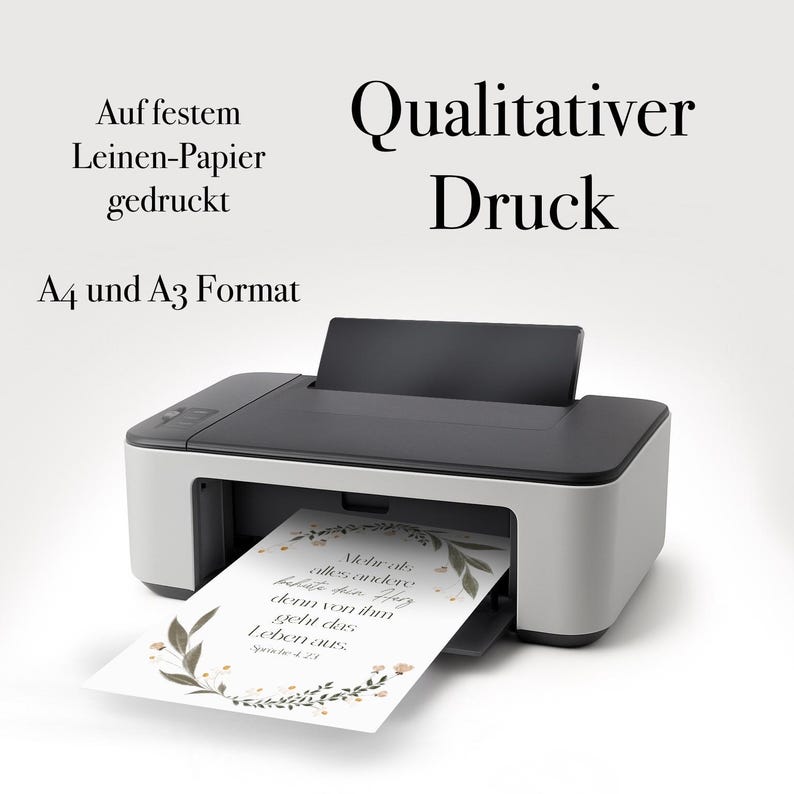 May include: A black and white printer with a sheet of paper emerging from the output tray. The paper has a floral design and text. The image also includes the text "Qualitativer Druck".