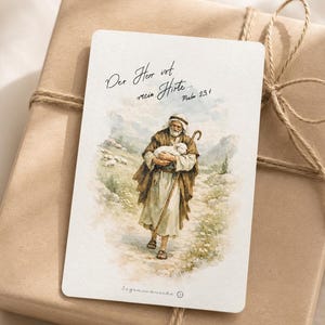 May include: A rectangular card featuring a watercolor illustration of a shepherd carrying a lamb, with a wooden staff and a mountainous landscape in the background. The text reads "Der Herr ist mein Hirte... Psalm 23,1" and "Segenswünsche".