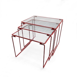 Beautiful vintage set of three red metal & glass Nesting Tables from the 1980s