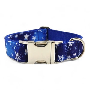 May include: A blue dog collar with a white star pattern and a silver buckle.