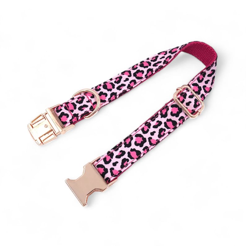 May include: Pink and black leopard print dog collar with gold-tone hardware.