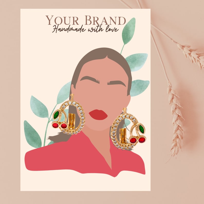 May include: Gold hoop earrings with a cherry design. The earrings have red and green stones and are set against a white background with a woman's illustration.