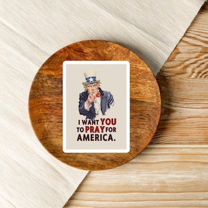 May include: A rectangular sticker featuring Uncle Sam pointing at the viewer. He wears a blue coat, a white and blue hat, and a red bow tie. The text reads, "I WANT YOU TO PRAY FOR AMERICA."