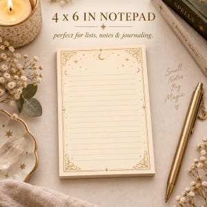 May include: A rectangular 4 x 6 inch notepad with cream-colored paper featuring horizontal lines and gold-toned celestial border designs including stars and a crescent moon. The top of the notepad displays the text 4 x 6 IN NOTEPAD.