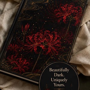May include: A black hardcover journal featuring a vibrant red spider lily illustration with gold filigree accents. A circular black sticker is attached to the cover with the gold text: Beautifully Dark. Uniquely Yours. PERFECT FOR JOURNALING, WRITING & DREAMING.