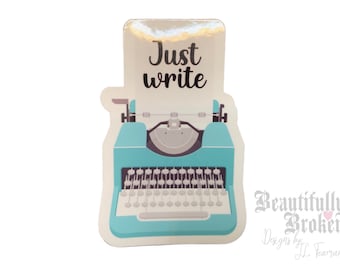 May include: A teal blue vintage typewriter with the text "Just write" on a white paper sheet. The sticker is from "Beautifully Broken Designs by JL Fearon".