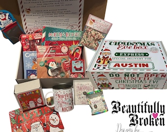 May include: A Christmas Eve box filled with holiday treats and activities. The box includes a mug, candy, a book, and a letter. The box is decorated with Santa Claus and reindeer illustrations. The box is labeled "Christmas Eve Box Express, Special Delivery for Austin."