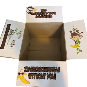 May include: An open cardboard box with a monkey theme. The box has a white background with brown monkeys and bananas. The text on the box reads "No monkeying around" and "I'm going bananas without you!"