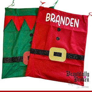 May include: Two personalized Christmas Santa sacks. One is red with a black belt and gold buckle, the other is green with red trim. The red sack has the name "BRANDEN" in white. Both have black buttons and drawstrings.