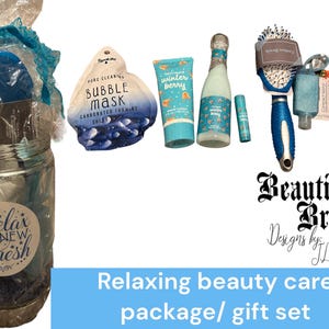 May include: A relaxing beauty care gift set with a variety of products. Includes a jar with bath items, a bubble mask, lotion, a small bottle, a lip balm, a hairbrush, a compact mirror, and a round item that says "GIRL BOSS".