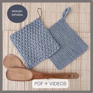 May include: Two gray knitted pot holders with a textured pattern. The pot holders have a loop handle. The pot holders are on a woven bamboo mat. The text "PDF + VIDEOS" is at the bottom of the image.