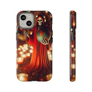 May include: A phone case featuring a skeletal figure in a red robe holding a globe, surrounded by candles. The design has a dark, mystical theme with a detailed illustration and a glossy finish.